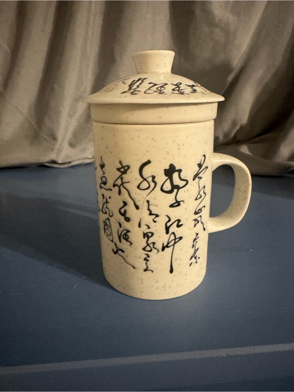 white ceramic or porcelain Chinese tea infuser mug